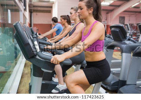 Group of people on exercise bicycles in the gym