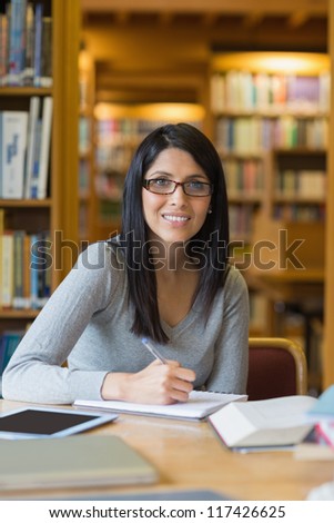 Black-haired woman doing some research in the library