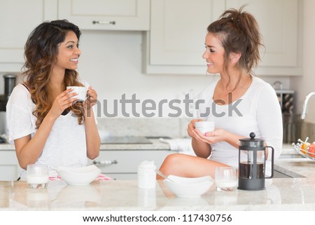 Friends having coffee at breakfast in kitchen
