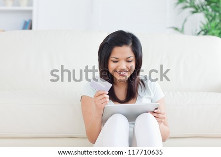 Woman sitting on the floor in front of a sofa in a living room