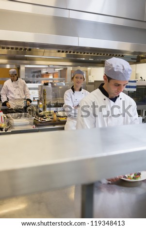 Three Chef\'s cooking in the restaurant kitchen