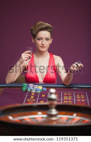 Woman playing roulette alone in casino