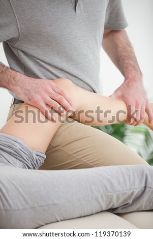 Leg of a patient being placed on the doctor in a room