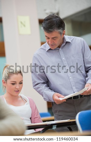 Teacher is looking talking to the student at the classroom