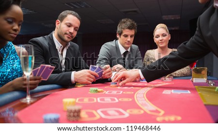 People playing poker at the table in casino