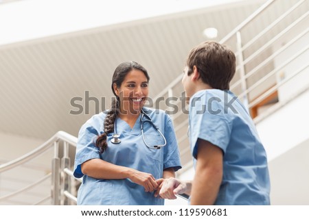Nurses talking on stairs in hospital