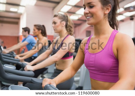 Group of people on exercise bicycles in the gym