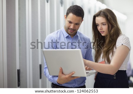 Two employees reading data analyses