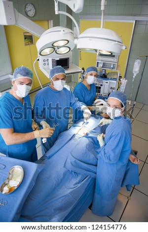 Surgery team looking at camera during operation in a surgery theater