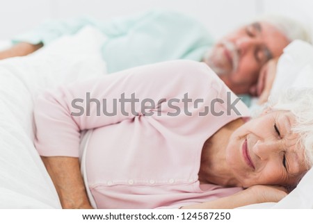 Elderly couple sleeping in bed