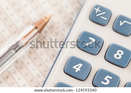 Sector of calculator and biro on maths tables