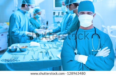 Surgeon standing with arms crossed