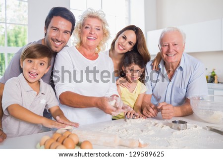 Smiling family baking together in the kitchen