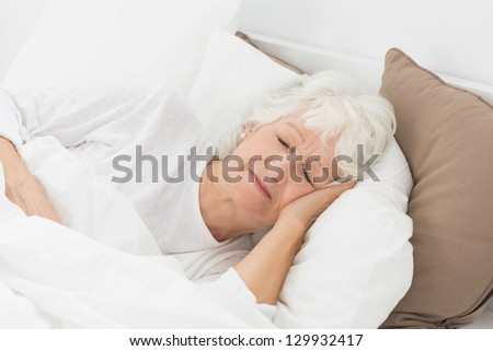 Old woman sleeping on the bed