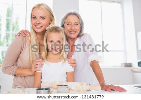 Cheerful mothers and daughters cooking together in the kitchen
