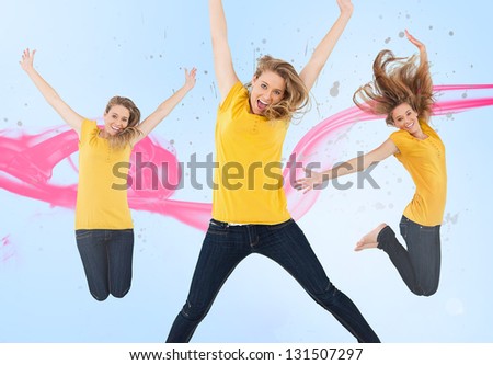 Three of the same young woman jumping for joy with pink smoke trail on blue background
