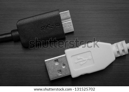 White USB and black USB SS on black background
