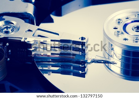 Close up of hard disk drive in blue tint of computer