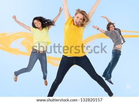 Three happy friends jumping for joy with yellow smoke trail on blue background