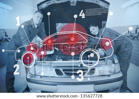 Two happy mechanics consulting futuristic interface with car diagram and statistics