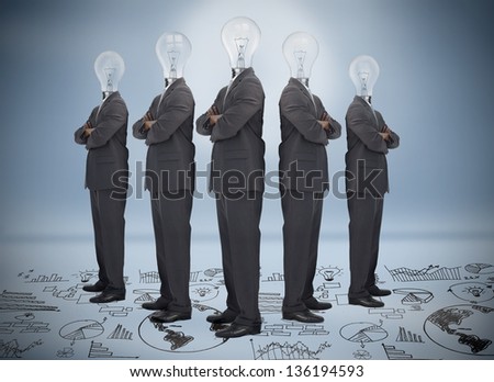 Businessman with bulb head multiplied standing on floor of graphs on blue background