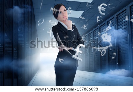 Businesswoman standing and thinking in data center with currency graphics