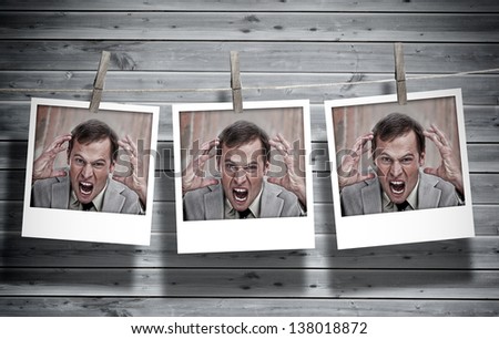 Three instant photos of an angry businessman hung with pegs with wooden boards on the background