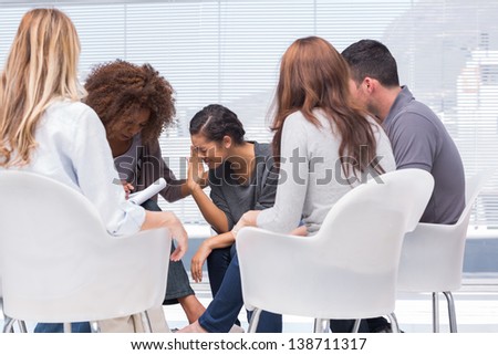 Woman telling her problems and crying during group therapy