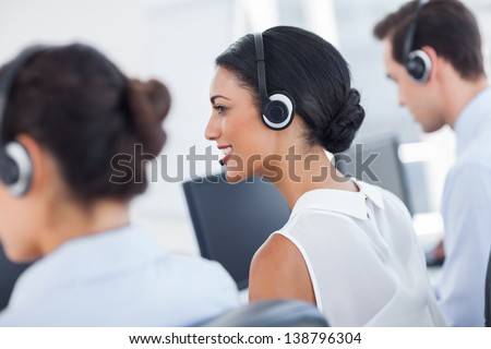 Three call centre employees working in line