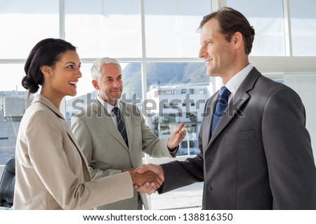 Businessman introducing a colleague to another businessman
