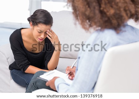 Woman getting depressed on sofa in therapy
