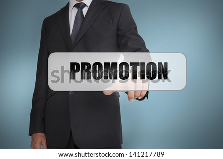 Businessman selecting the word promotion written on white tag on blue background