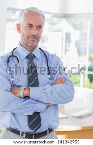 Doctor with arms folded looking away