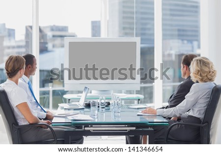 Business people looking at a screen during a video conference