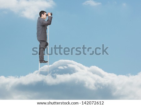 Businessman standing on ladder over the clouds and looking at the horizon with binoculars