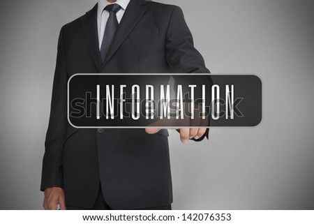 Businessman selecting the word information written on black tag on grey background