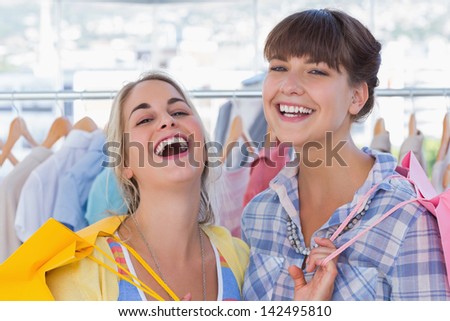 Women with shopping bags laughing together