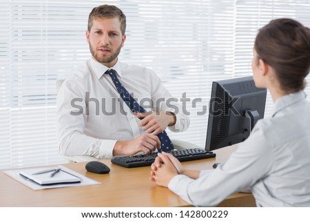 Businessman meeting with a colleague at his desk in the office