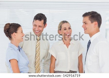 Business people laughing together in office