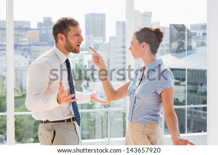 Business team having a heated argument in a bright office