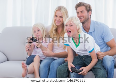 Family playing video games in the living room