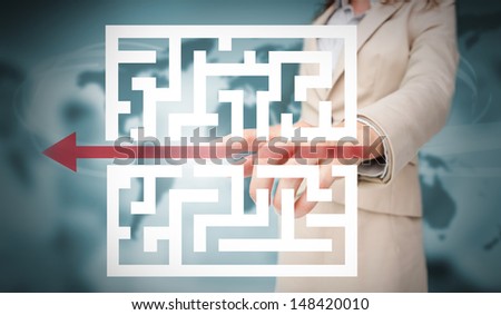 Businesswoman tracing red arrow through qr code on blurry office background