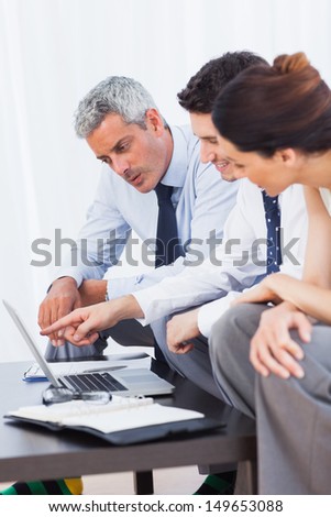 Business people working with their laptop on sofa at office