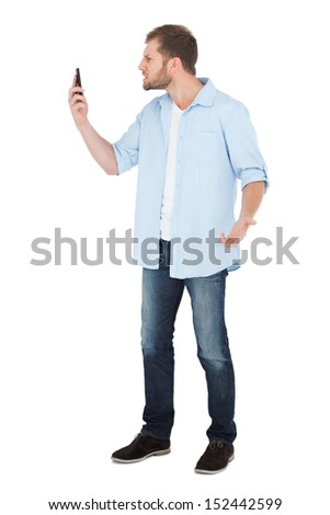 Angry model on the phone on white background