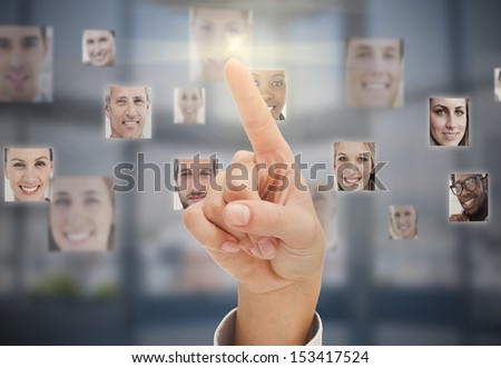 Finger touching futuristic interface showing human faces