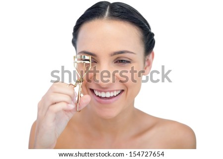 Smiling natural model with eyelash curler on white background