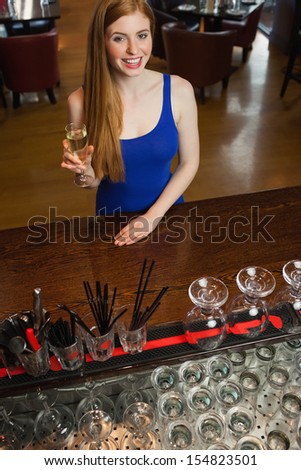 Attractive woman having a flute of champagne in a classy bar