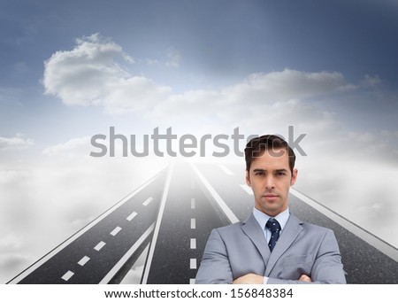 Composite image of young businessman looking at camera standing on streets floating in the sky