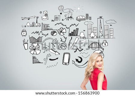 Beautiful woman standing back to camera looking over shoulder in front of economic illustrations on grey background