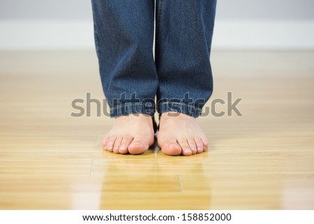 Close up of bare male feet on wooden floor